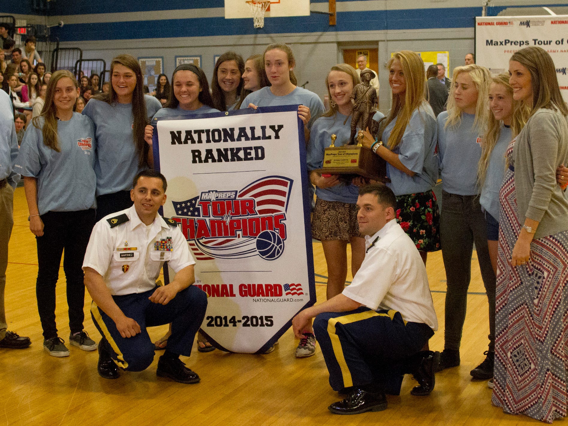NJSIAA Tournament of Champion winners Manasquan High School Girls Basketball poses with trophy and Army National Guard Staff Sargeants Angelo Martinez and Anthony Larobina. Photo taken at Manasquan High School in Manasquan NJ on May 15, 2015.