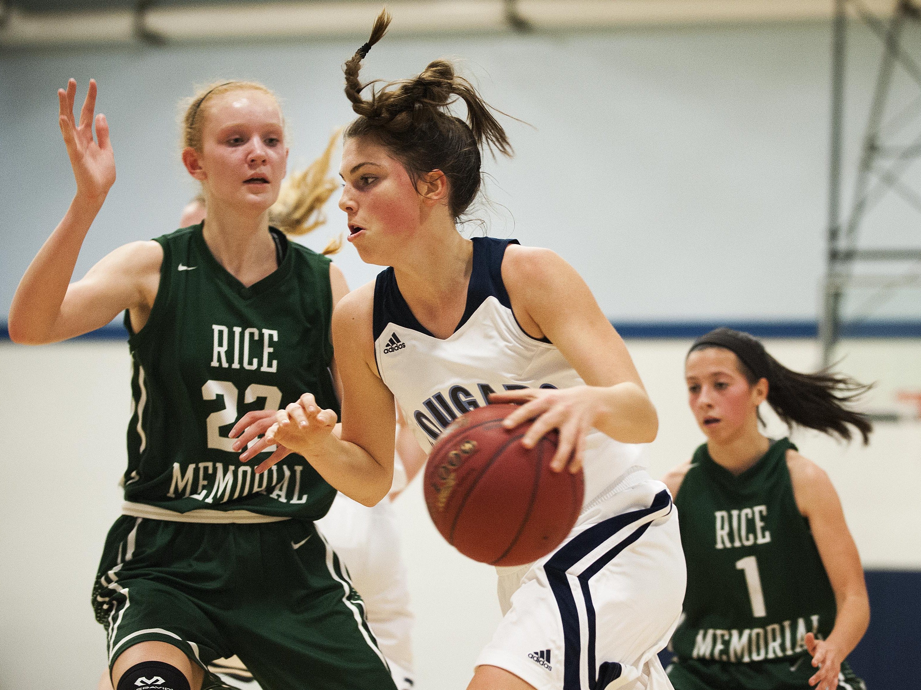 Mount Mansfield forward Perry Willett (5) drives to the hoop past Rice forward Lizzy Lyman (22) during the girls basketball game between the Rice Green knights and the Mount Mansfield Cougars at MMU High School on Friday night December 4, 2015 in Jericho.