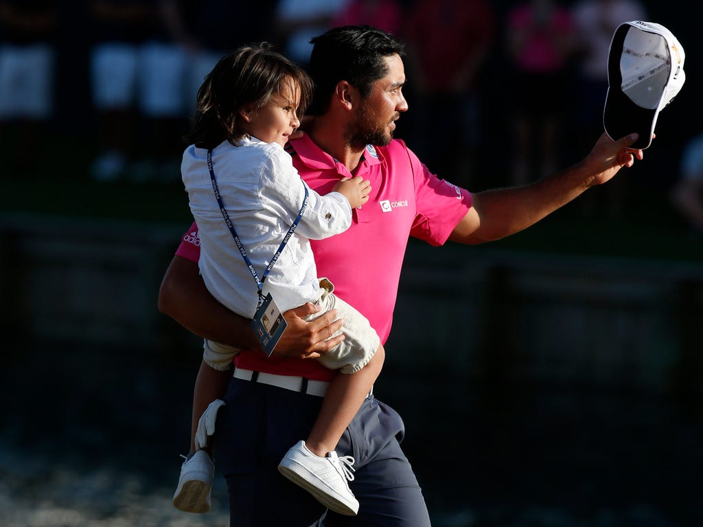 Jason Day celebrates with son Dash after winning the 2016 Players Championship golf tournament at TPC Sawgrass - Stadium Course at Ponte Vedra Beach, Fla.
