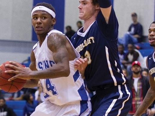 Schoolcraft College’s Tyler Johnson guards Lansing Community College’s Javon Haines, left, during a recent contest.