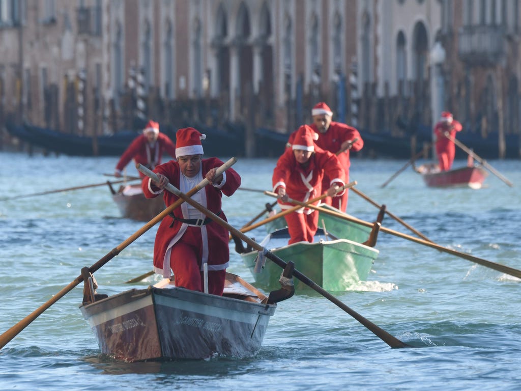 People dressed as Santa Claus take part in a regatta on the Grand Canal of Venice, on Dec. 17, 2017.