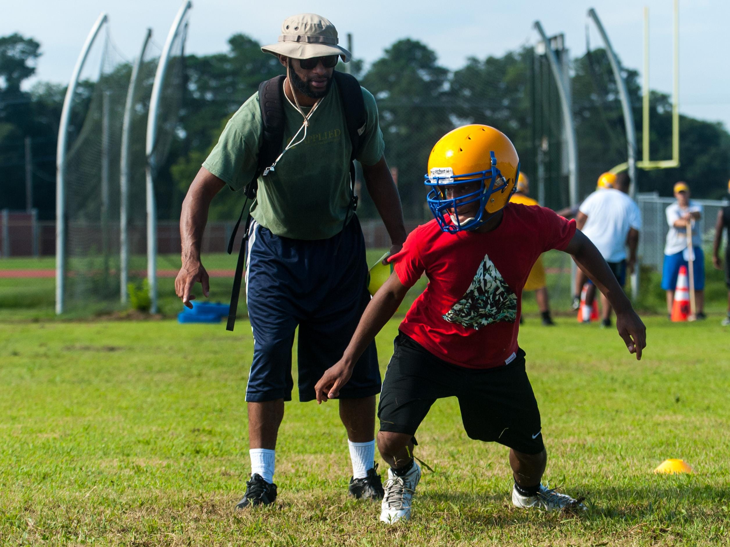 Wicomico High defensive backs work through drills.