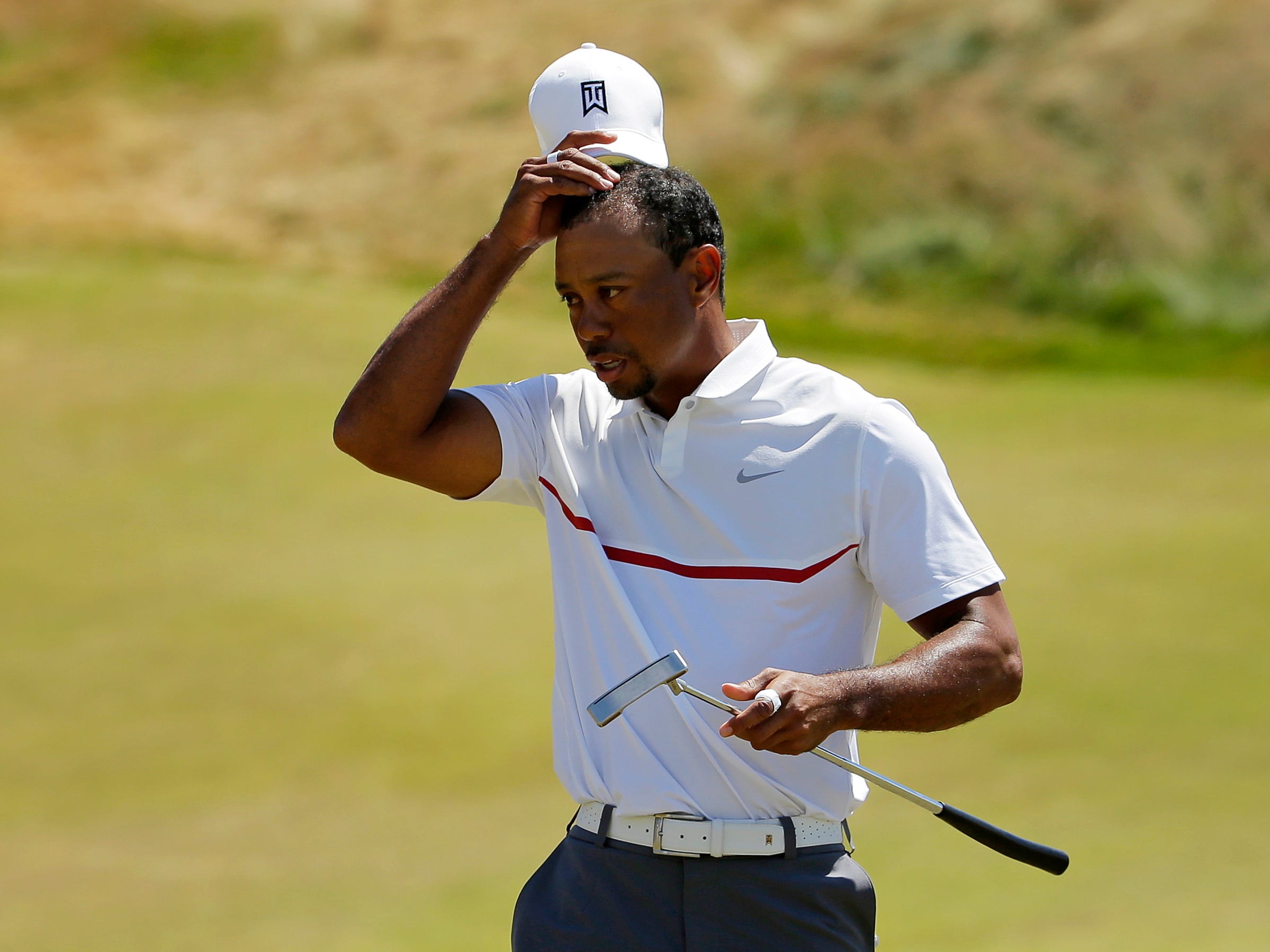 Tiger Woods removes his hat after his second round in the U.S. Open golf tournament at Chambers Bay on Friday, June 19, 2015 in University Place, Wash. (AP Photo/Ted S. Warren)