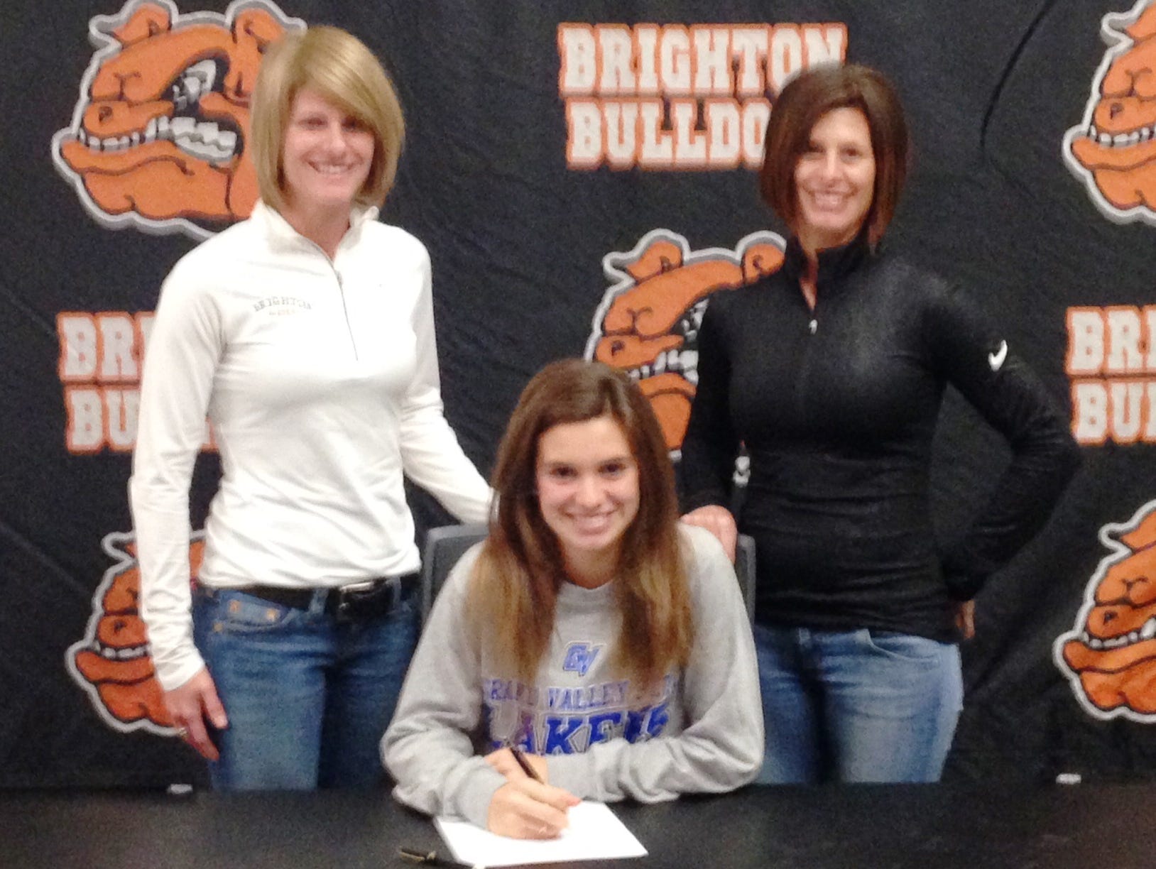 Brighton's Jenna Sica signed with Grand Valley State University on Wednesday alongside her cross country coach Kristi Matuszewski, left, and her mom Shelly, right.