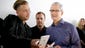Apple CEO Tim Cook, right, looks at the new iPhone