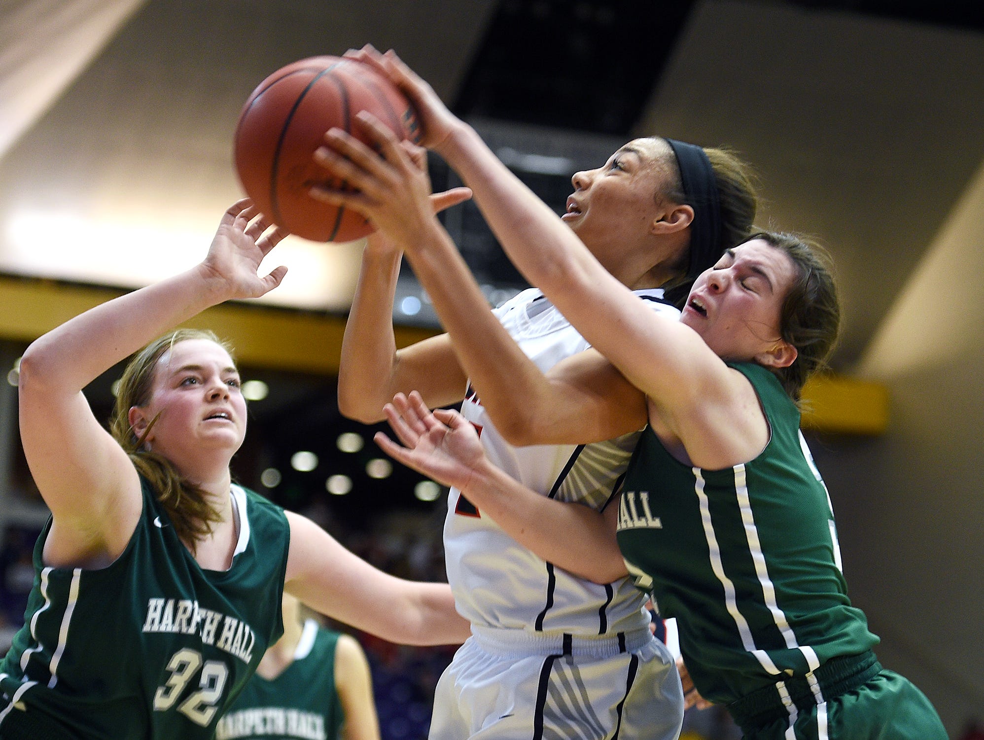 Brentwood Academy's Makaila Wilson (14) is fouled while shooting against Harpeth Hall's Mary Triplett (3) during the TSSAA DII-AA semifinals at Lipscomb University on March 4, 2016.