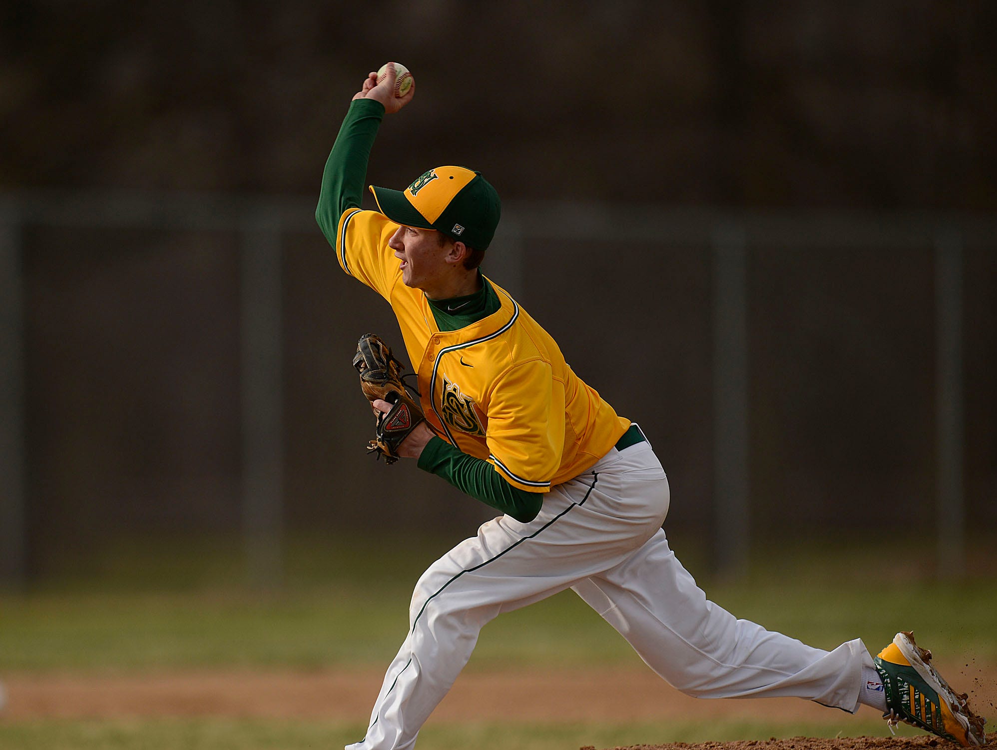 Ashwaubenon pitcher Turner Wittig (3) gets ready to fire a pitch during Tuesday's baseball game against De Pere at Ashwaubomay Park in Ashwaubenon.