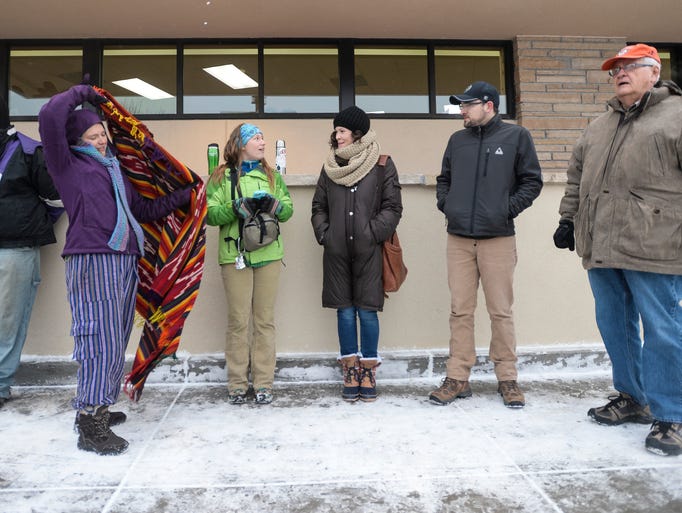 People wait in line at Trader Joe's before the store's