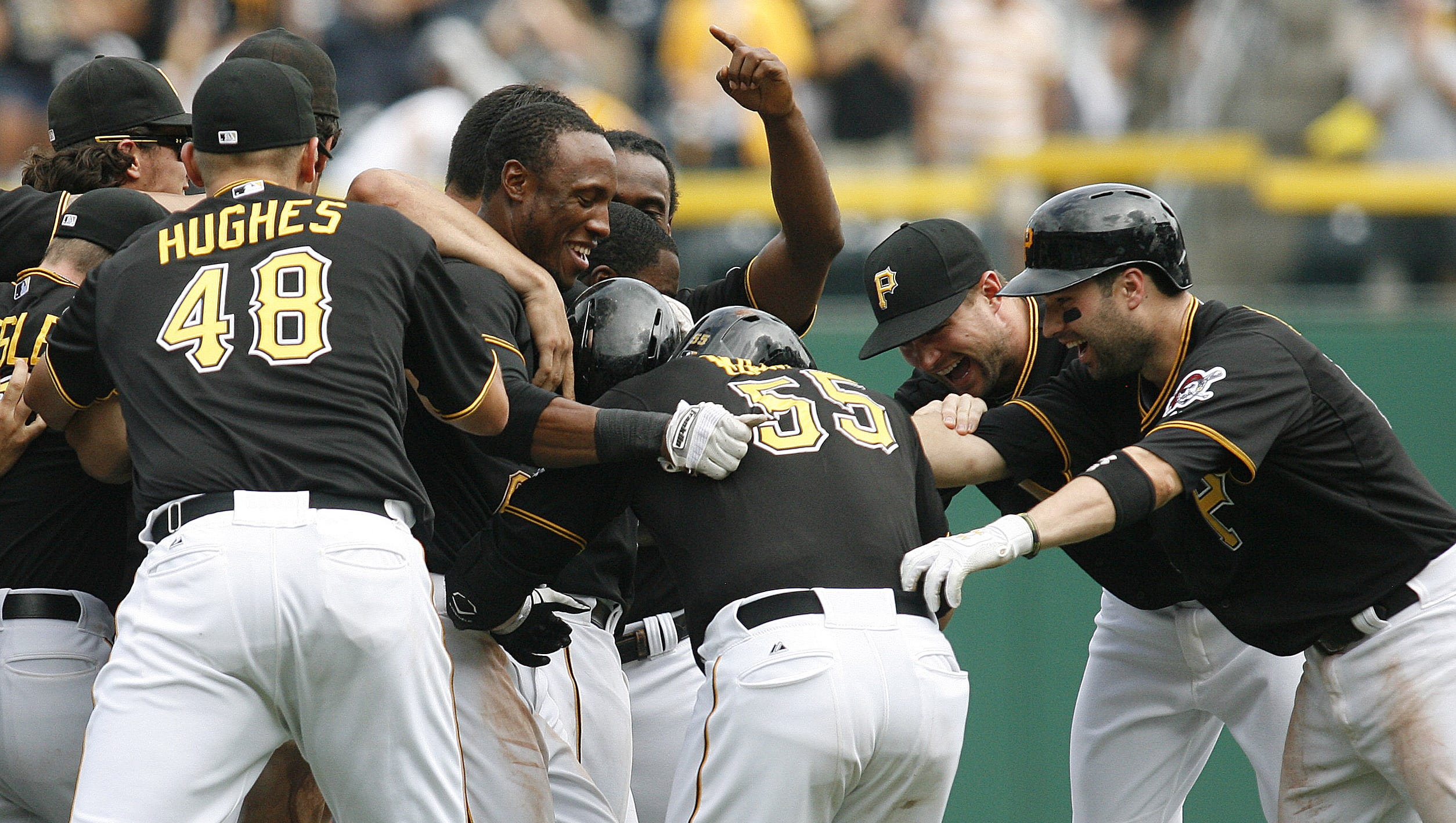 Aug. 8: Pirates catcher Russell Martin (center) is mobbed by teammates after driving in the game-winning run against the Marlins in the 10th inning.
