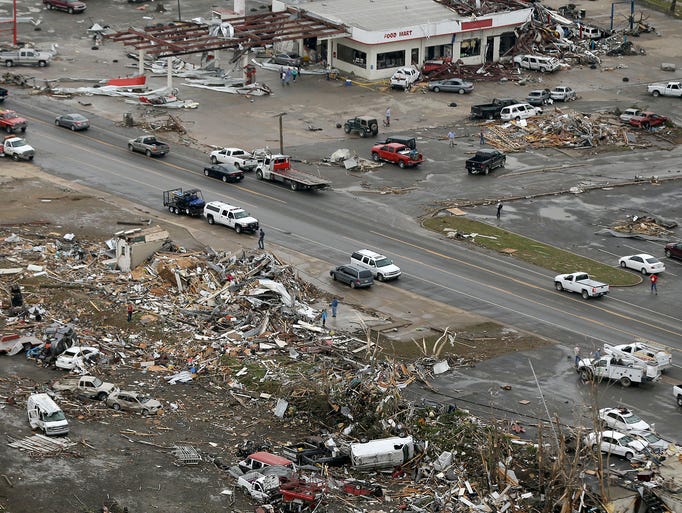 Homes and businesses are wrecked in downtown Vilonia, Ark.