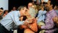 Bush kisses his mother Barbara as his son George, right,