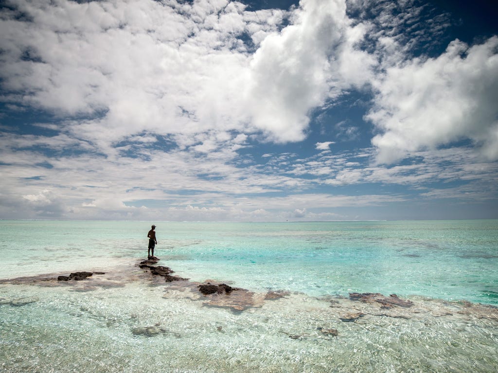 A man stands at the Tagoi motu near the Toau atoll in the French polynesia.
