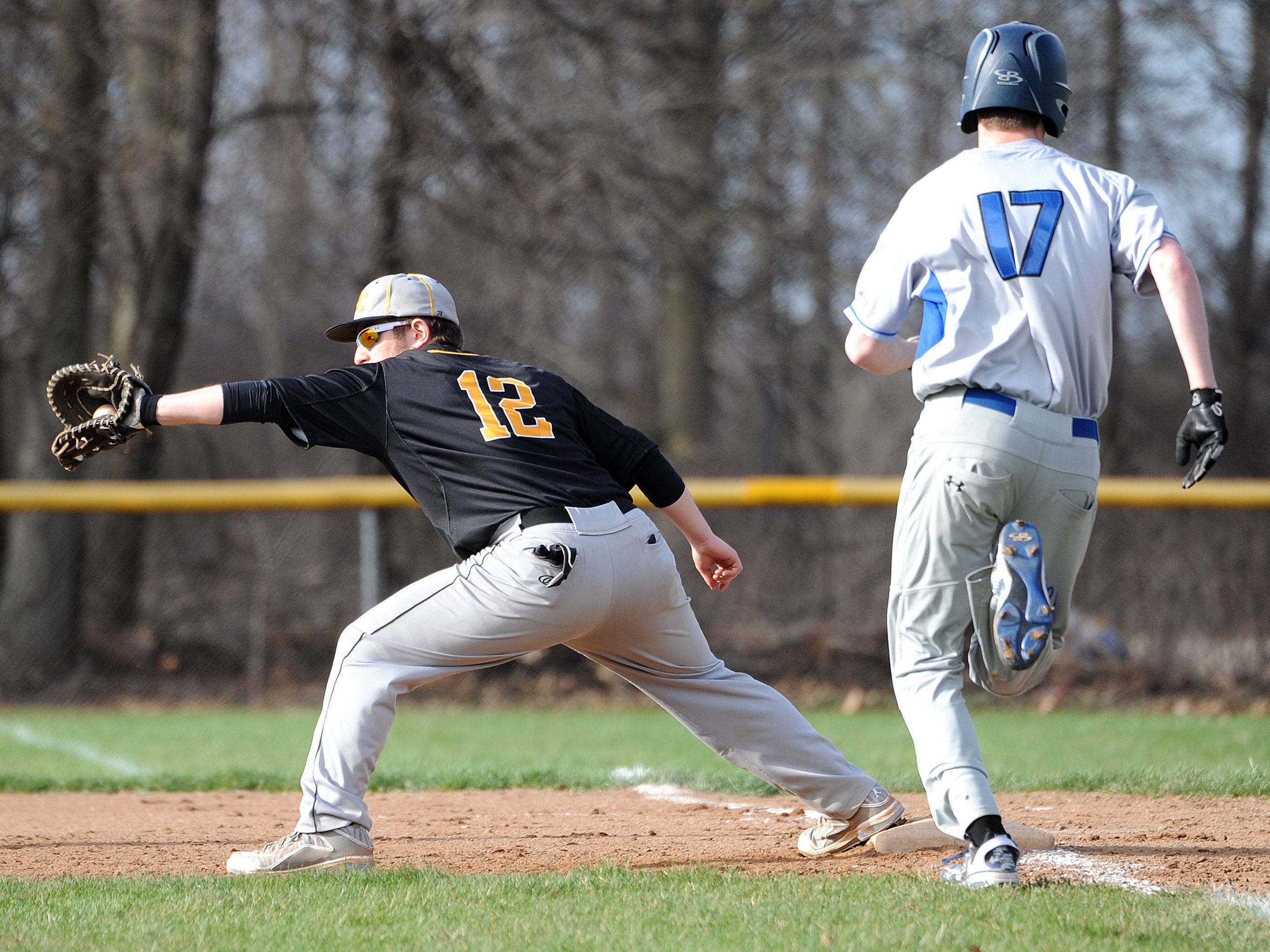 Colonel Crawford’s Dylan Burkhart makes the catch and gets Wynford’s Wyatt Smith out during a game Tuesday evening.