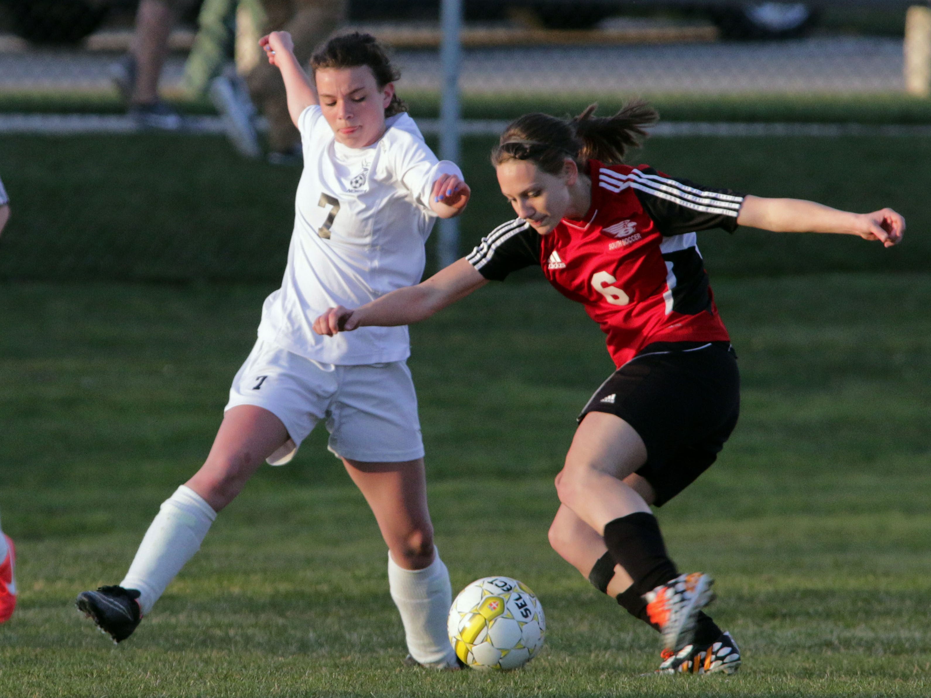 Sheboygan North's Mallory Veeser (7) and Sheboygan South's Baylee Rivas (6) battle for the ball Tuesday at the Horace Mann Soccer Complex.