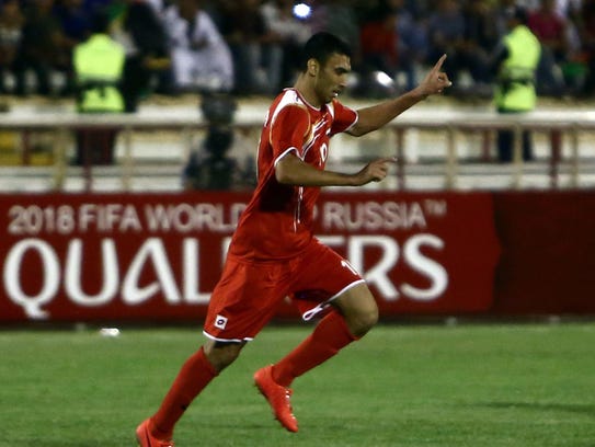 Abdulrazak al-Husein of Syria celebrates scoring his