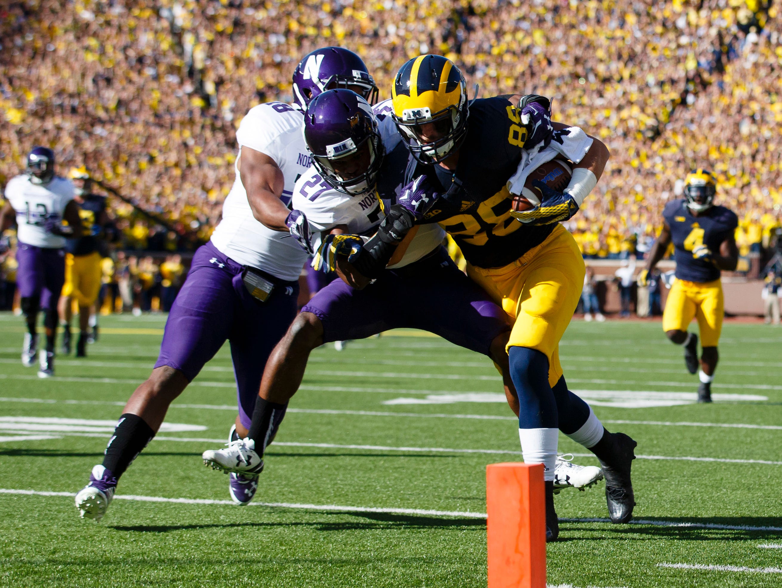 Oct 10, 2015; Ann Arbor, MI, USA; Michigan Wolverines tight end Jake Butt (88) is tackled just short of the end zone by Northwestern Wildcats cornerback Matthew Harris (27) in the first quarter at Michigan Stadium.