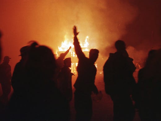 Participants run toward the site of a 50-foot-high