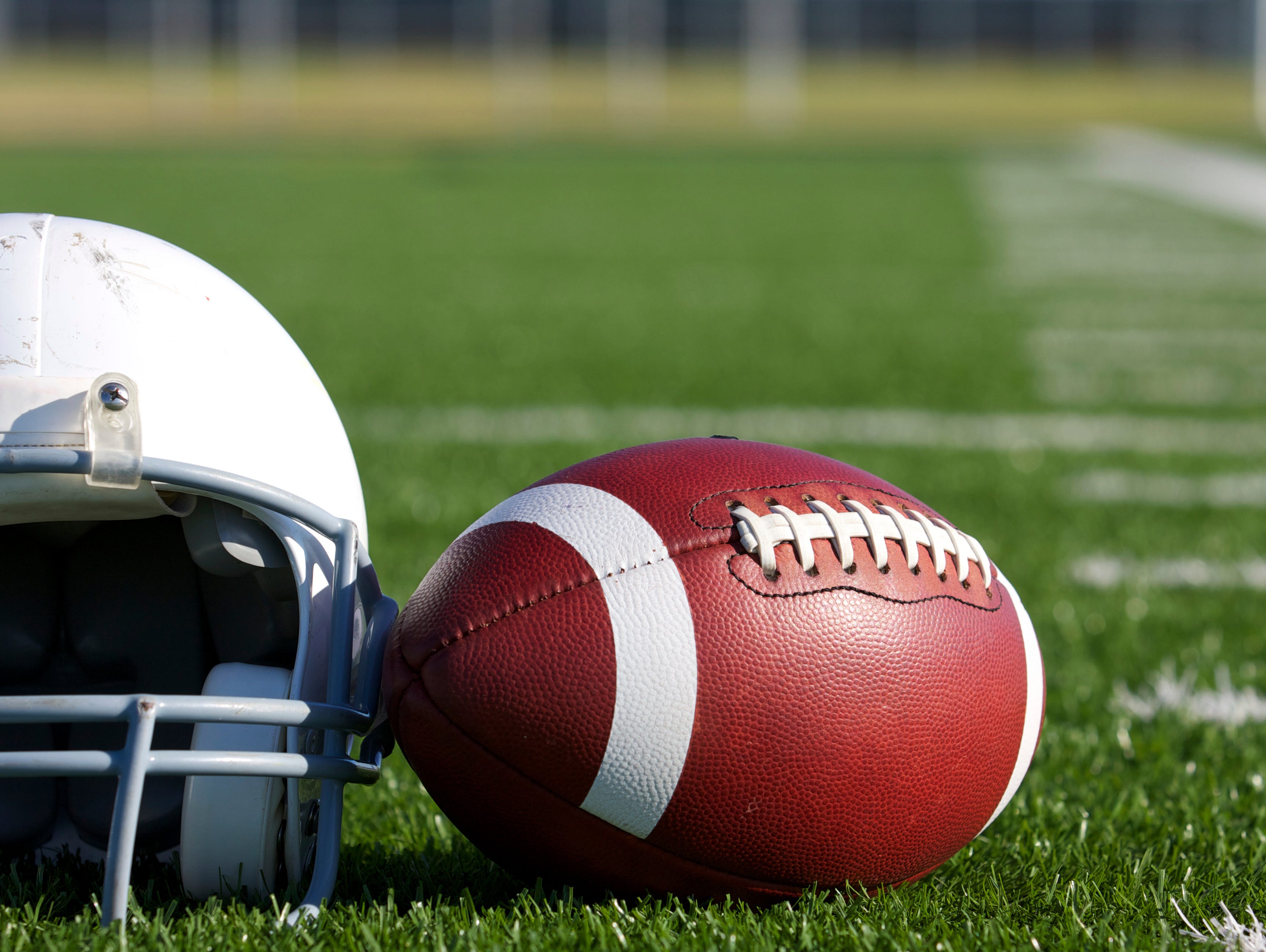 American Football and Helmet on the Field