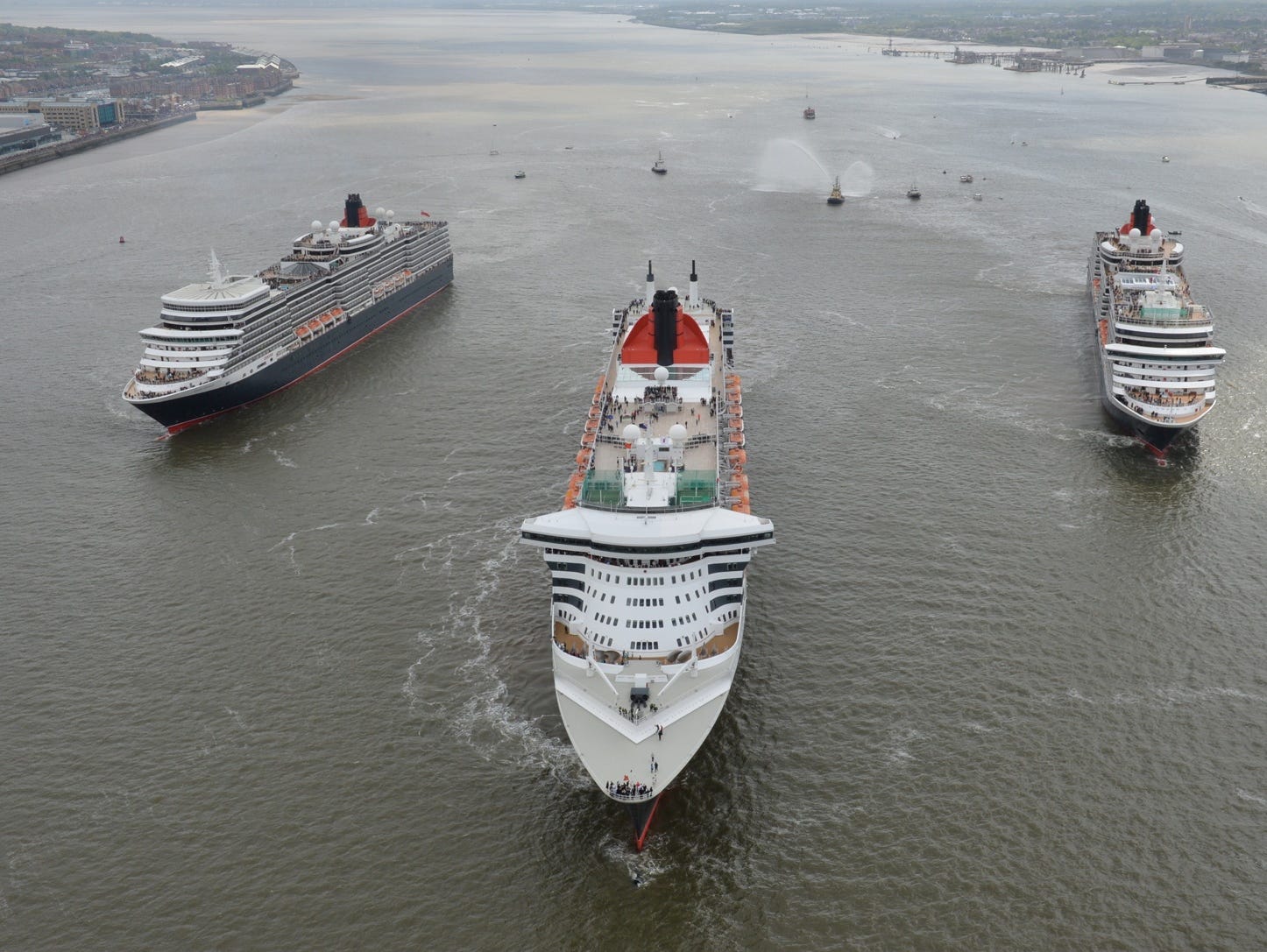 Queen Mary 2, Queen Victoria and Queen Elizabeth meet in the Mersey, Liverpool for a gathering in front of the Three Graces and thousands of people on the riverside.