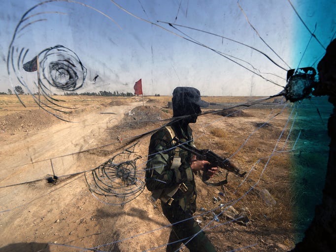 Iraqi Turkmen forces patrol a checkpoint in the northern city of Tuz Khurmatu close to locations of jihadist Islamic State of Iraq and the Levant (ISIL) fighters.