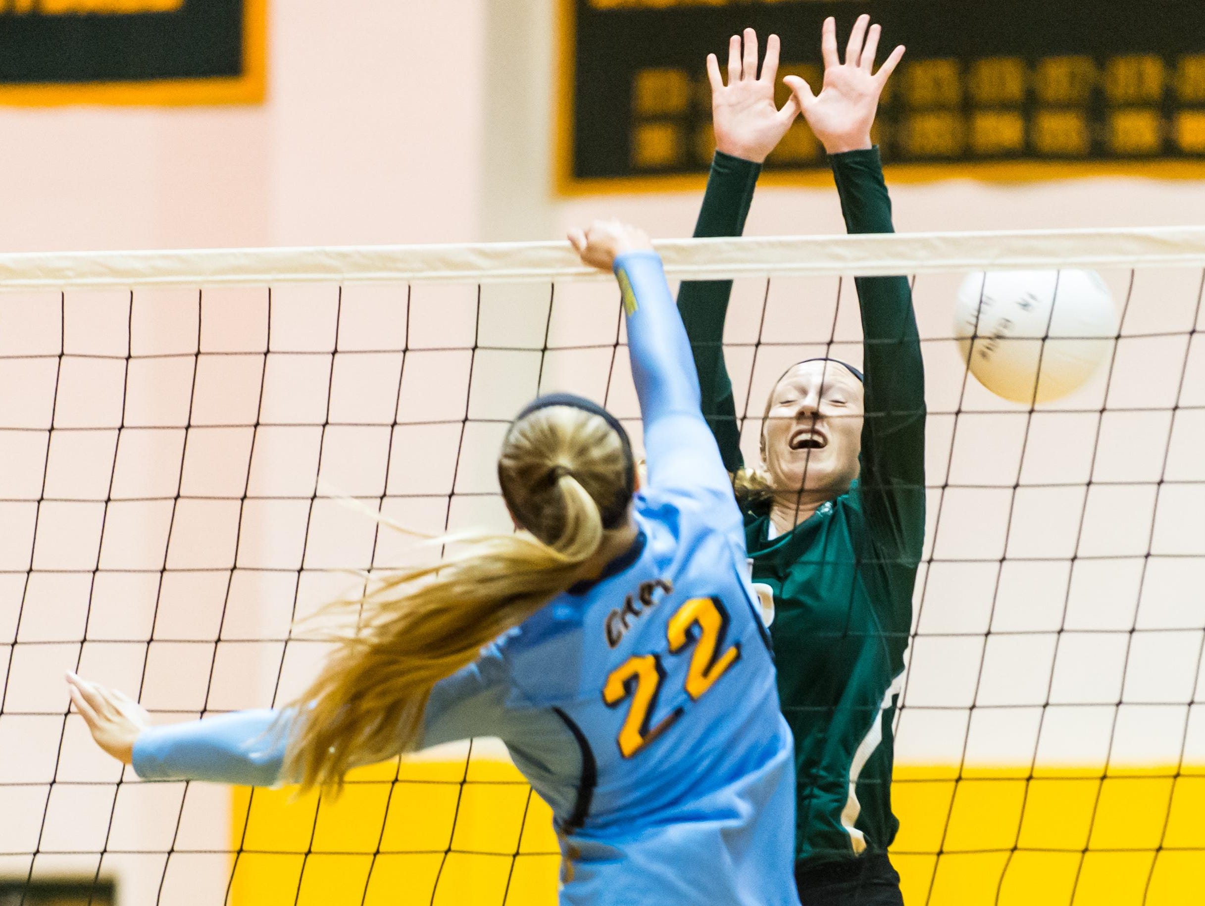 Cape Henlopen's Cameron Wick (22) slips a spike through Indian River's Julia Bomhardt (6) on Tuesday evening at Indian River.
