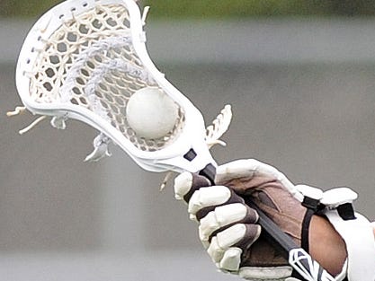 051813-Lewes,DE.-ch.dov.boyslacrosse-Capes Blake Mann moves the ball downfield as Cape Henlopen HS (white) defeated Dover HS (blue) 16-7 in the 2nd Round of the DIAA Boys Lacrosse Tournament at Cape Henlopen's Legends Field on Saturday May 18th. Photographer / Daily Times / Chuck Snyder