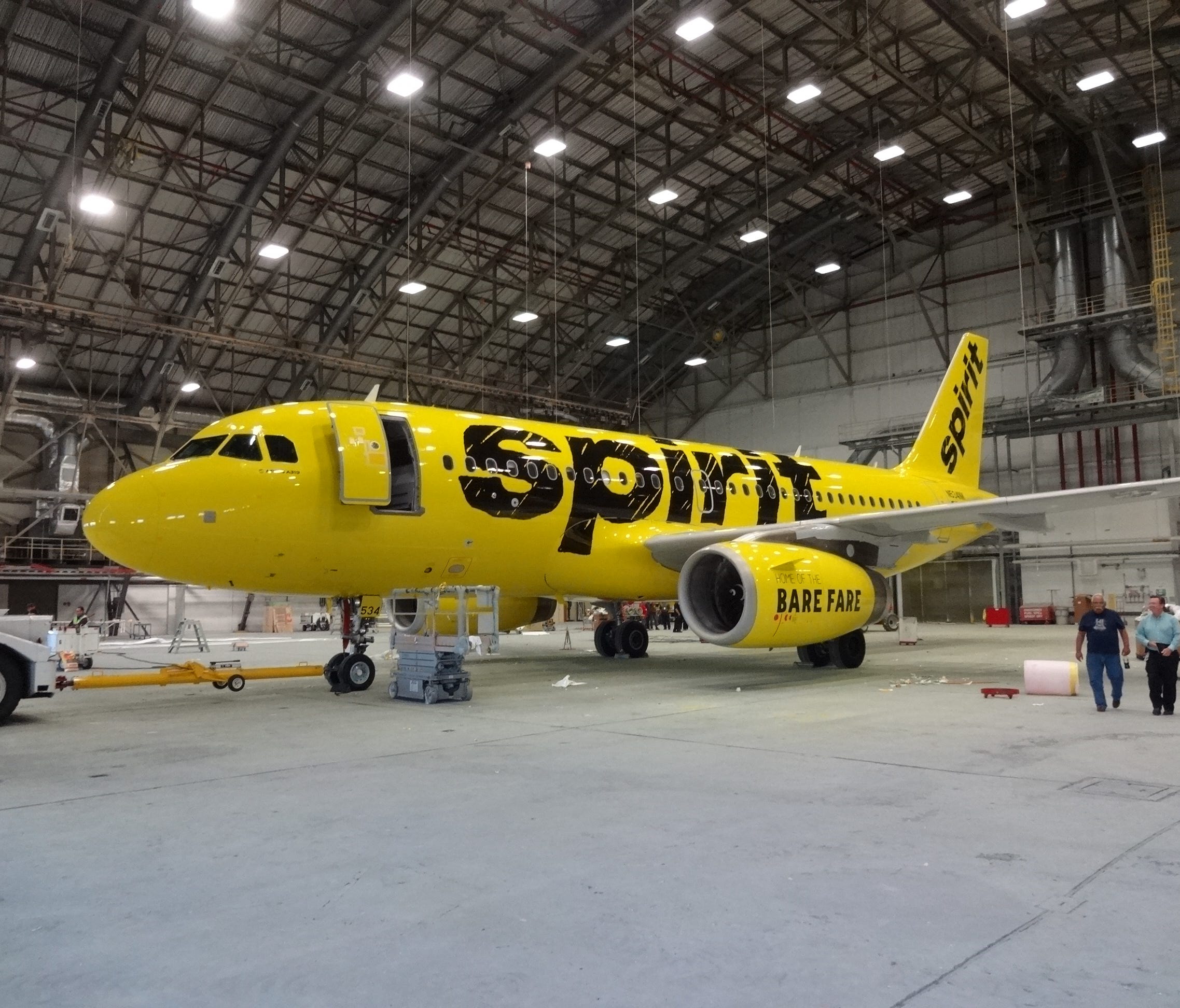 Spirit Airlines unveiled a dramatic new paint scheme for its planes, switching to this black-and-yellow scheme. Here, the first Spirit plane to get the new is seen Sept. 15, 2014, at the Premier Aviation Overhaul Center in Rome, N.Y.