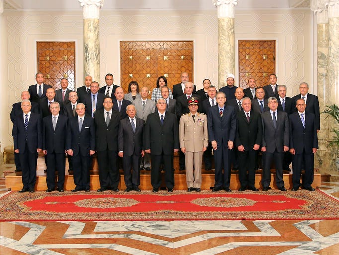 Interim President Adly Mansour, center, poses for an official photograph with his new Cabinet ministers at the presidential palace on July 16 in Cairo.