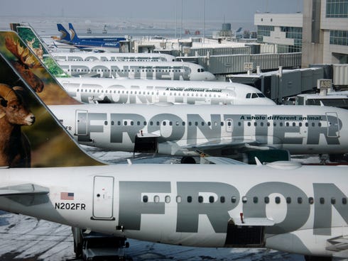 In this Monday, Feb. 22, 2010, file photo, Frontier Airlines jetliners sit stacked up at gates along the A concourse at Denver International Airport.  The airline is being sold to a private equity group.