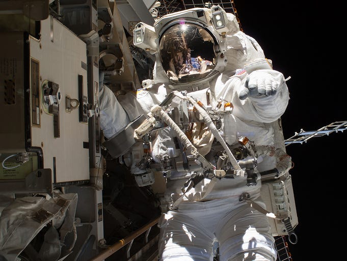 Astronaut Steve Swanson replaces a failed backup computer relay box on the International Space Station on April 22.