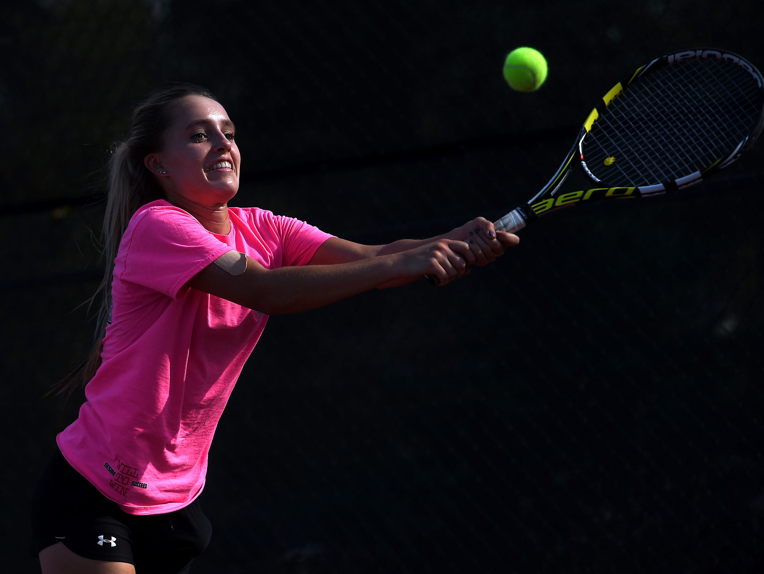 Reno High School's McKenna LeVitt hits a backhand during tennis practice in Reno on Sept. 28, 2016.