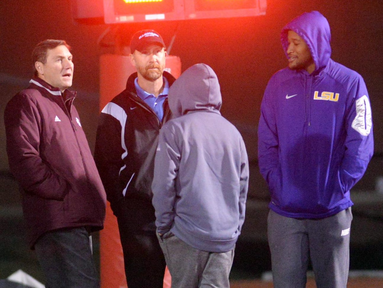 LSU quarterback Brandon Harris (right) chats with Mississippi State head coach Dan Mullen (left) while watching his former team compete against Zachary in a LHSAA Class 5A semifinal game Friday.