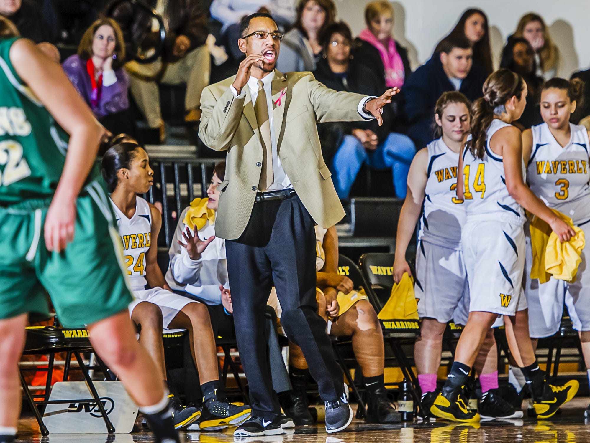 T.J. Hawkins directs the Waverly girls basketball team as they take on Lumen Christi in 2013.