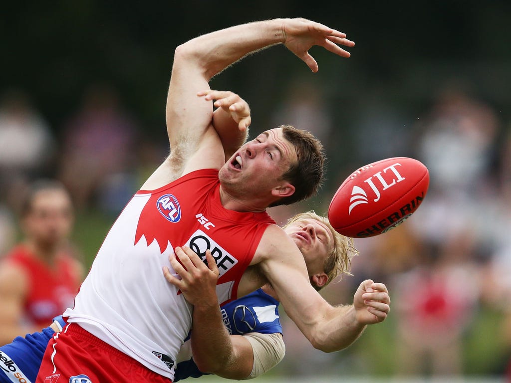 Harry Cunningham of the Swans is challenged by Corey Wagner of the Kangaroos during the 2017 JLT Community Series match between the Sydney Swans and North Melbourne Kangaroos at Coffs Harbour International Stadium in Coffs Harbour, Australia.