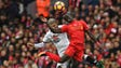 Watford's Valon Behrami (L) vies in the air with Liverpool's