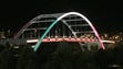 The John Seigenthaler Pedestrian Bridge is lit up with
