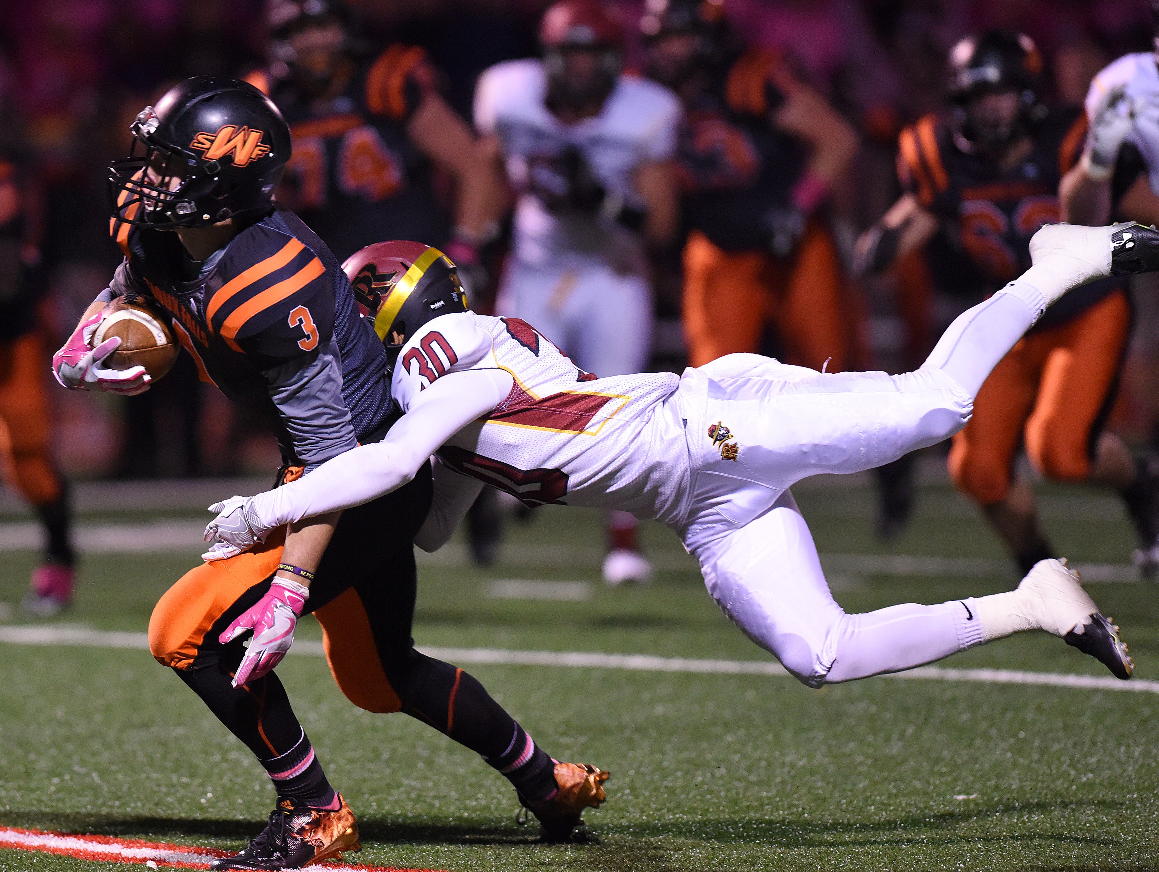 Washington's Logan Uttecht is tackled by Roosevelt's Dylan Garrow on Thursday at Howard Wood Field.