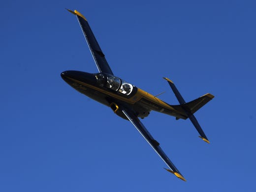 A racing plane makes its way around a pylon during