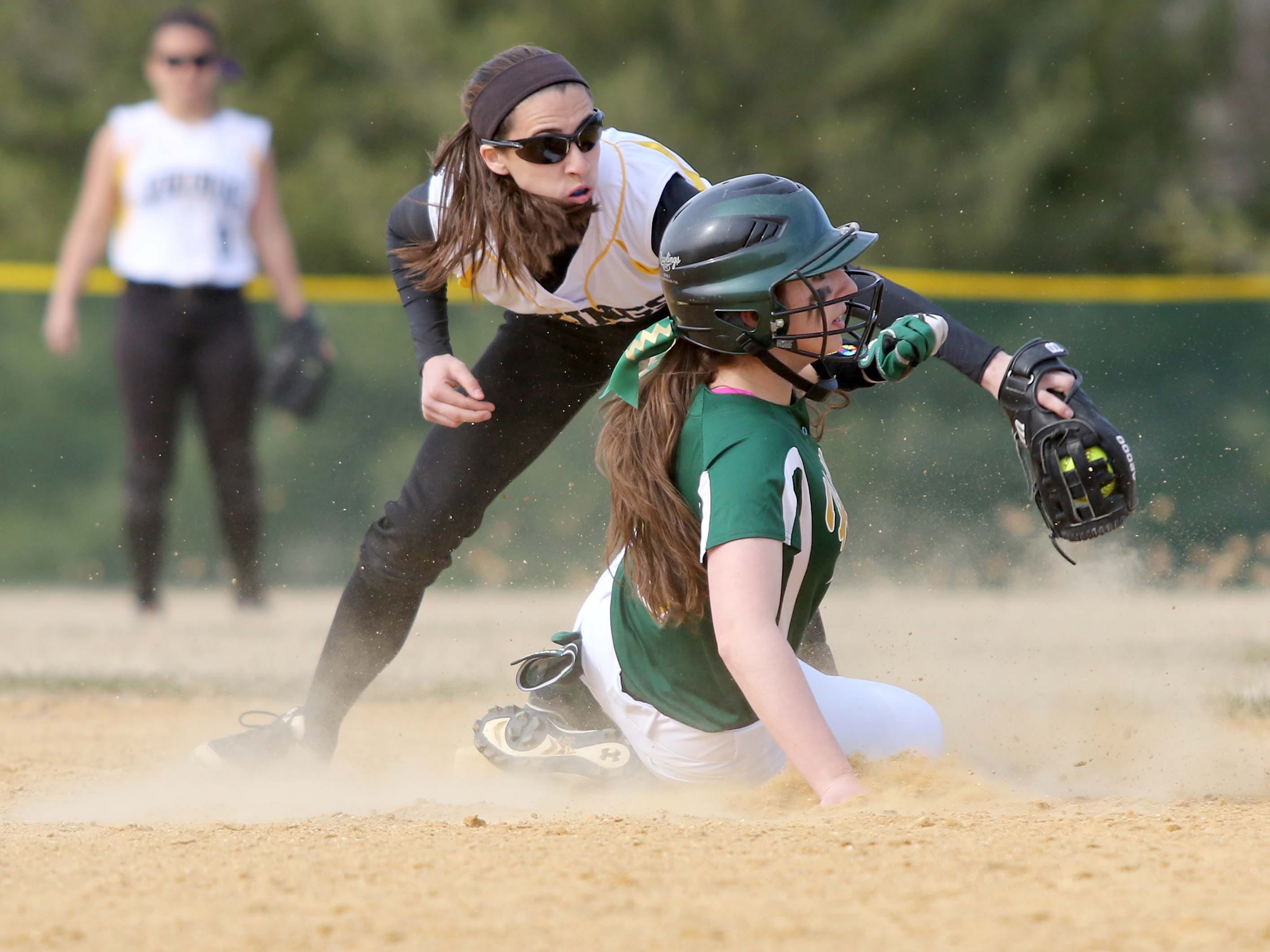South Brunswick's #1 Carly Rybinski applies a tag on #8 Kayla Smith of J.P. Stevens, at second base, as she tries to steal. High School softball, J.P. Stevens at South Brunswick, April 2, 2015