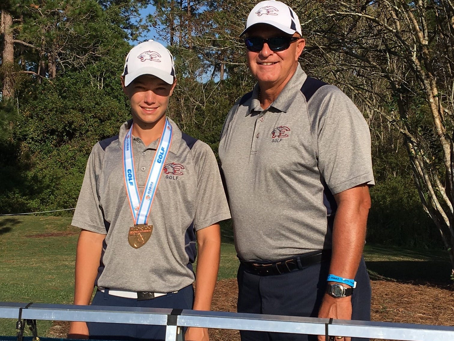 Estero's Luke Farmer and Wildcat head coach Bruce Buchla after Farmer tied for third overall at the 2A FHSAA Boys' Golf Championships at Mission Inn Resort in Howey-in-the-Hills, FL.