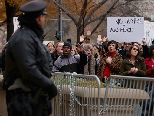 Security officers man barricades as demonstrators march