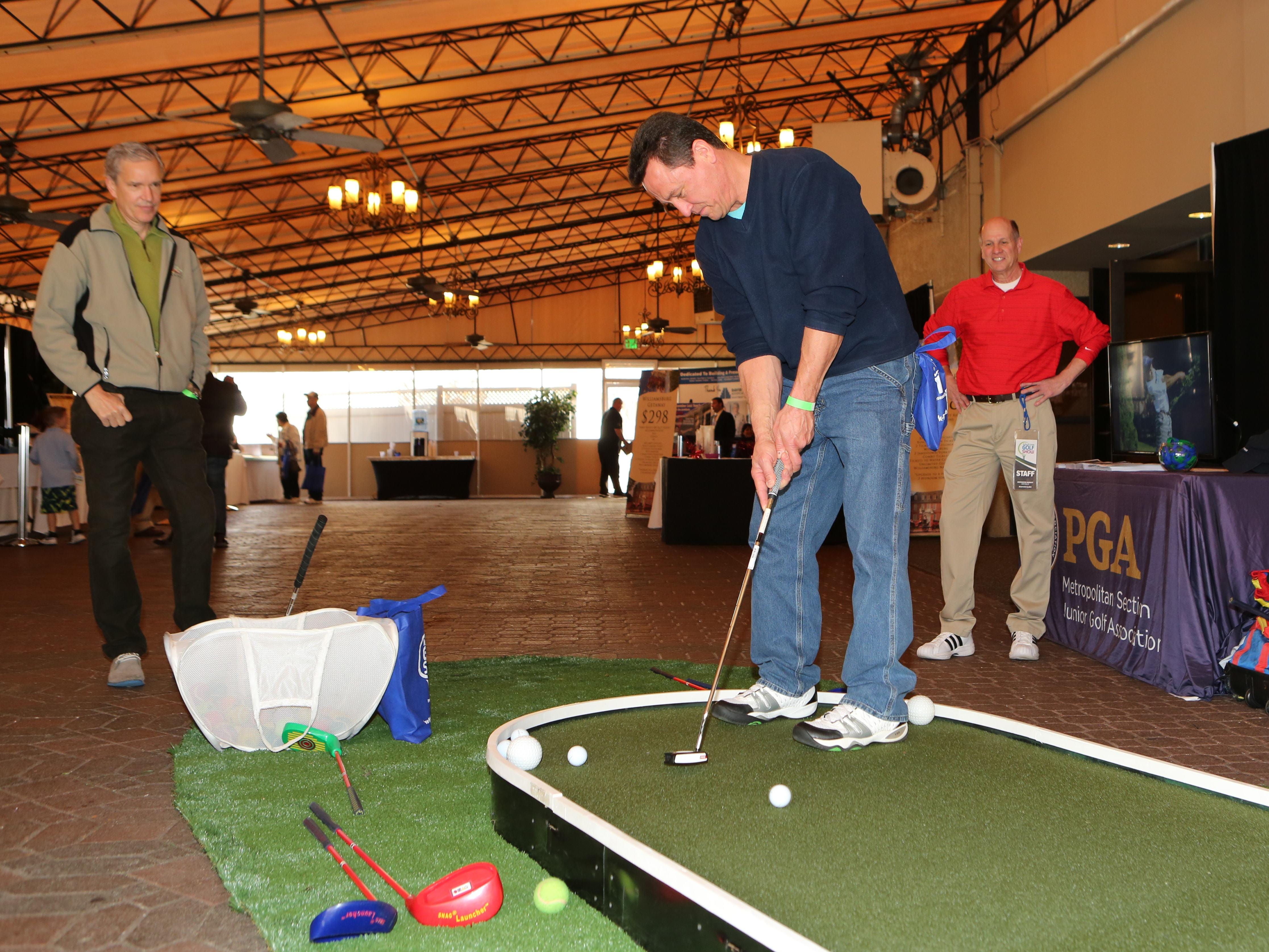 Joe Moravsky from Sherman, Connecticut, gives putting a try at the lohud.com Golf Show at the Westchester Marriott in Tarrytown Saturday. The show continues Sunday.