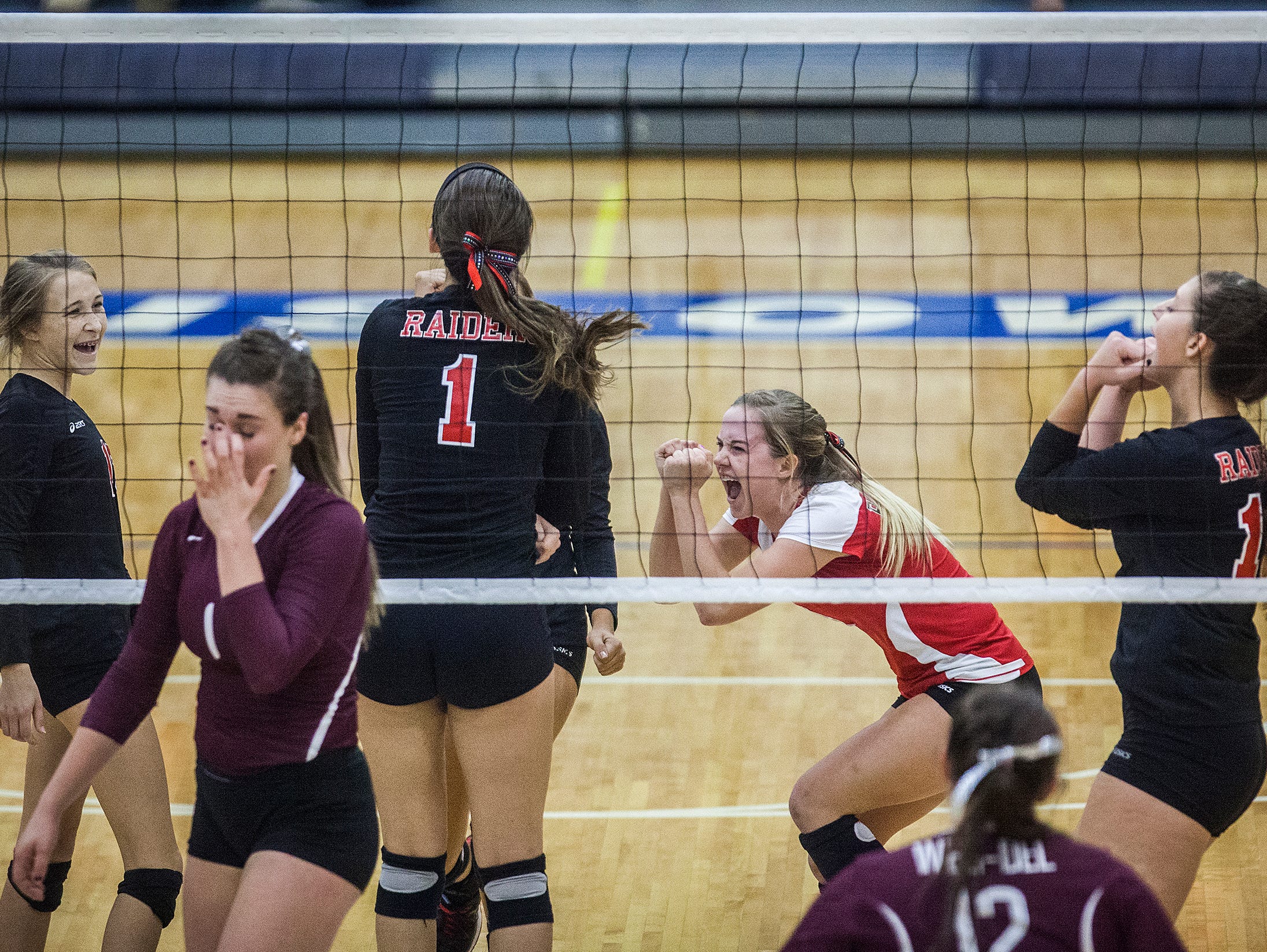 Wapahani celebrates a point against Wes-Del during their game at Ball Gymnasium Wednesday, Oct. 21, 2015.