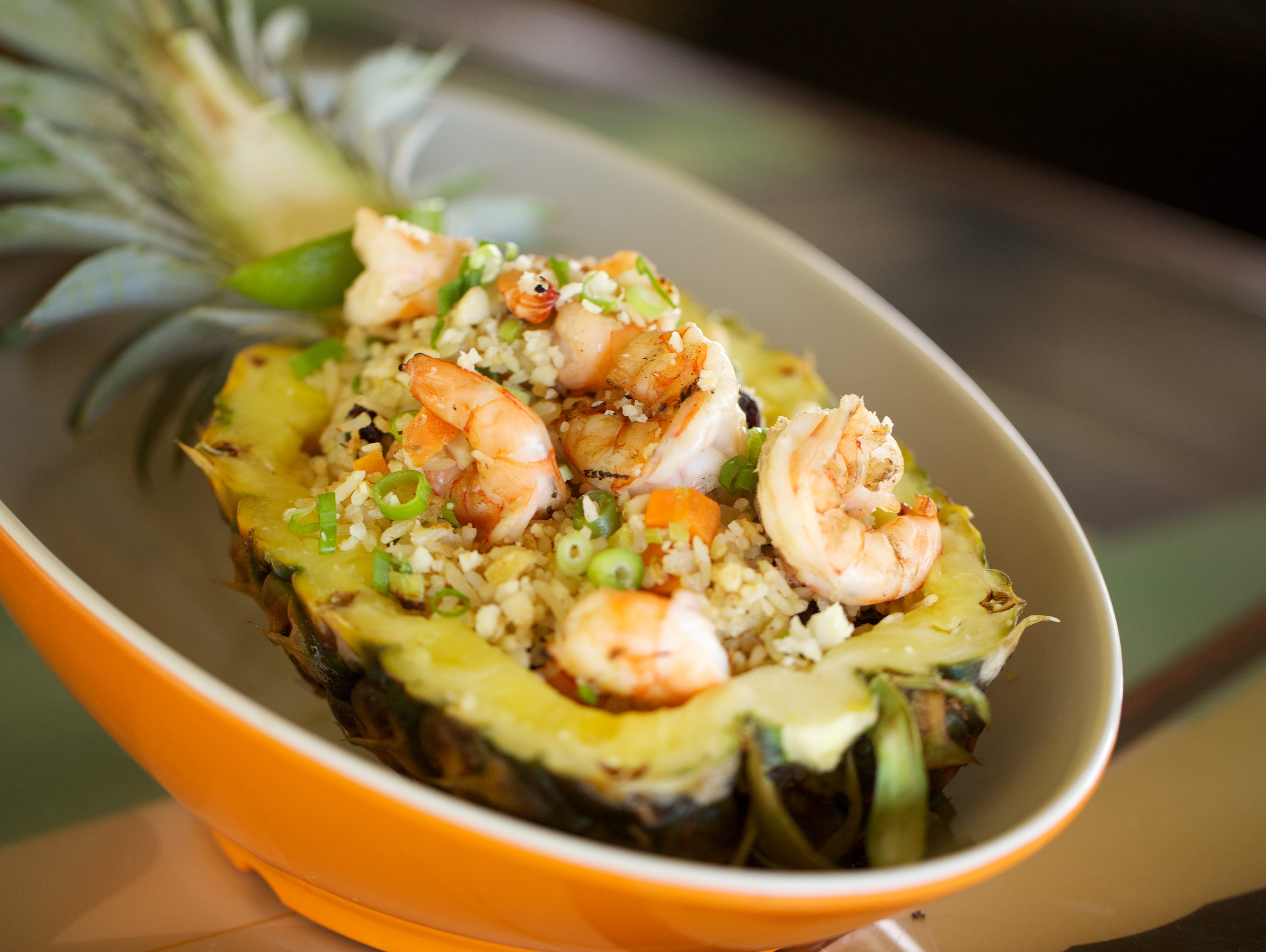 Located on Anaehoomalu Bay in the scenic Waikoloa Beach Resort, Lava Lava Beach Club’s open-air restaurant and bar is situated right on the beach. The pineapple fried rice bowl is attractively served in a half-pineapple, producing an island-style fee