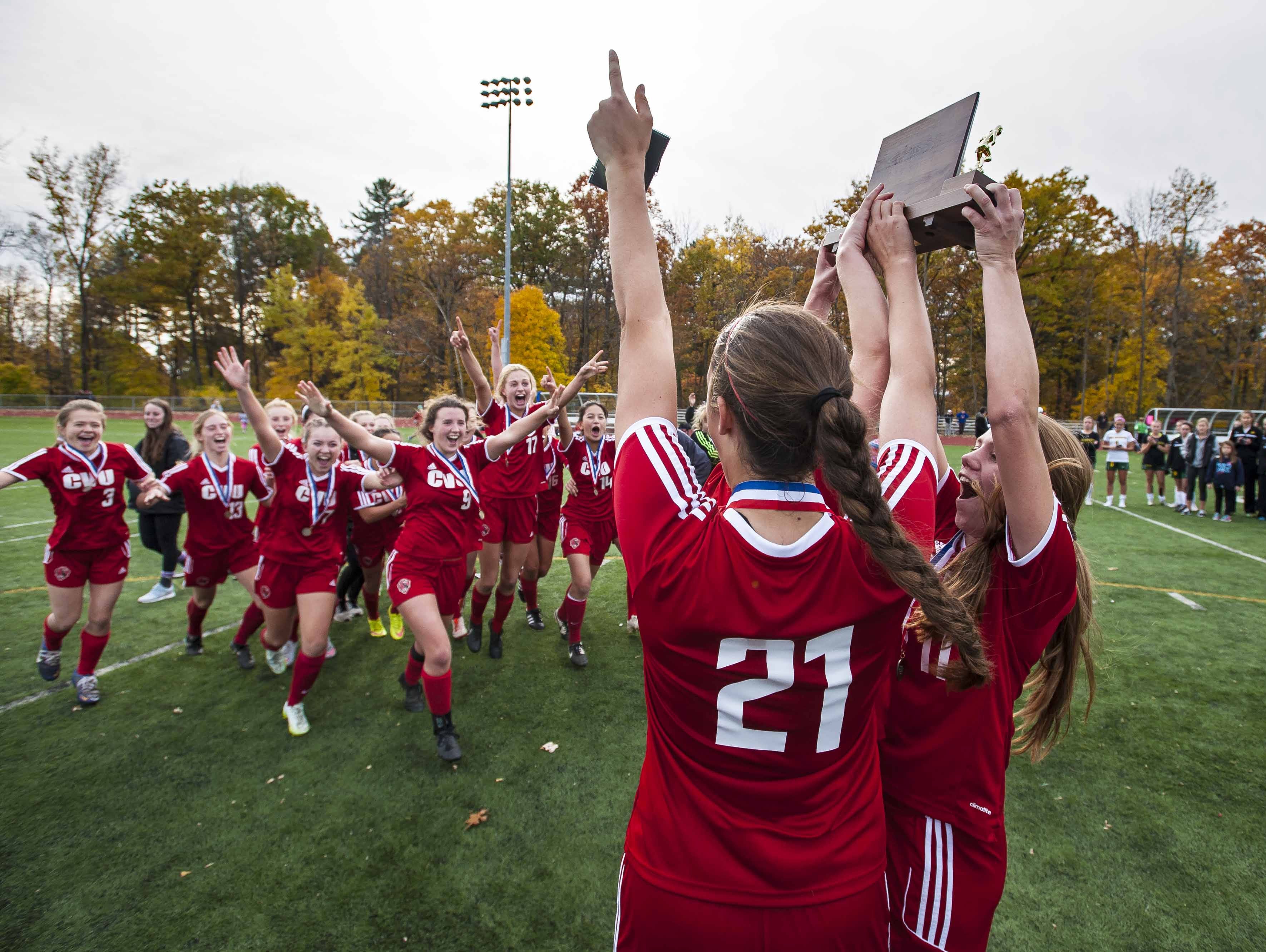 CVU celebrates its victory over Burr and Burton in the Division I girls soccer championship at Burlington High School on Saturday.