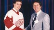 A young Steve Yzerman and Wings owner Mike Ilitch shake
