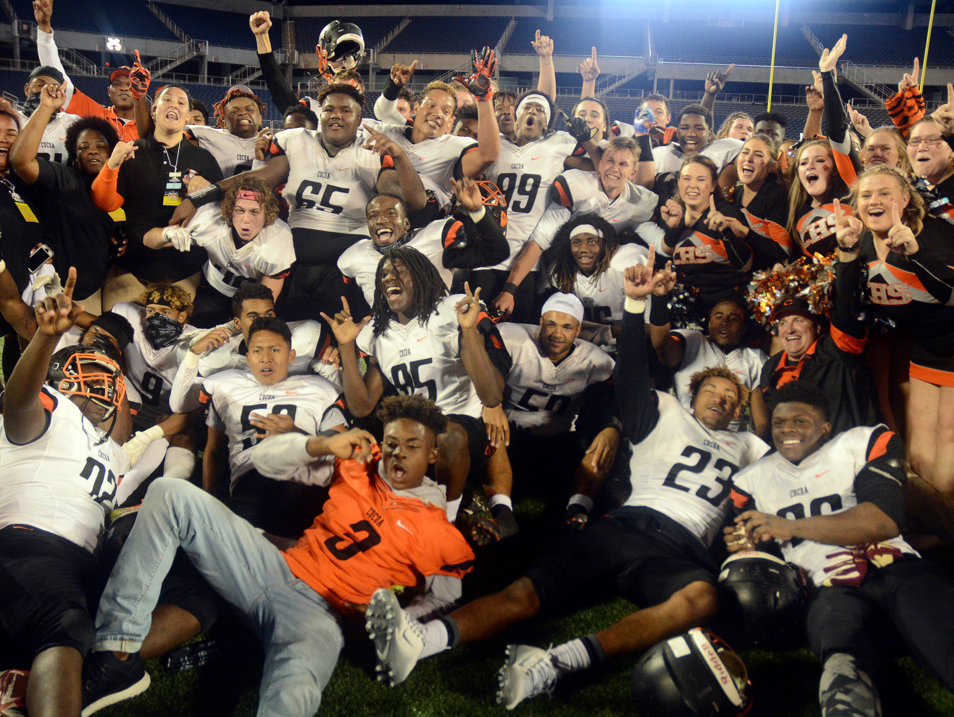 The Cocoa Tigers celebrate their Class 4A state football title Thursday evening in Orlando.
