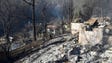 Remains of homes smolder on Tuesday, Nov. 29, 2016,