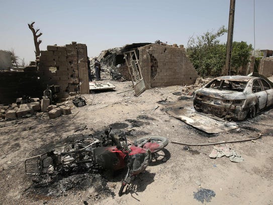A June 30, 2016, photo shows damaged vehicles in Fallujah,