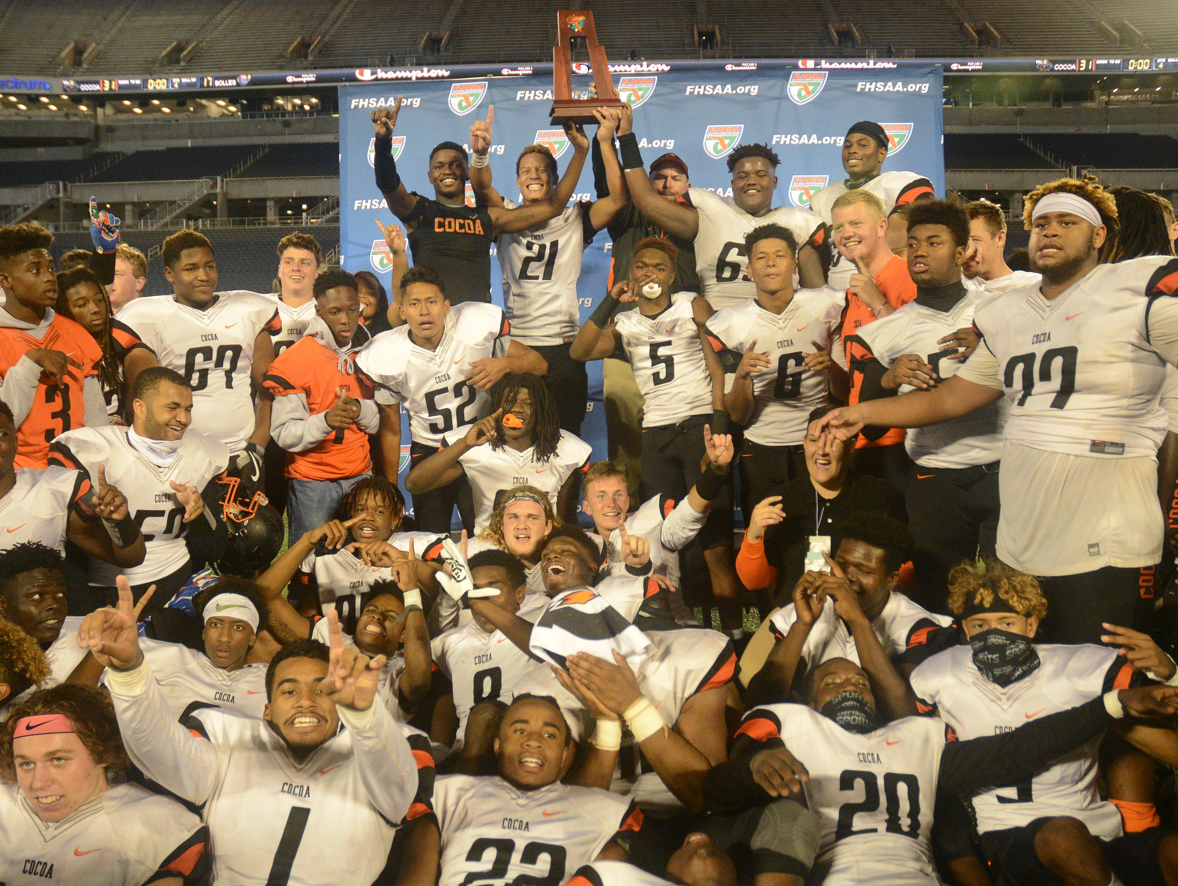 The Cocoa Tigers celebrate their Class 4A state football title Thursday evening in Orlando.